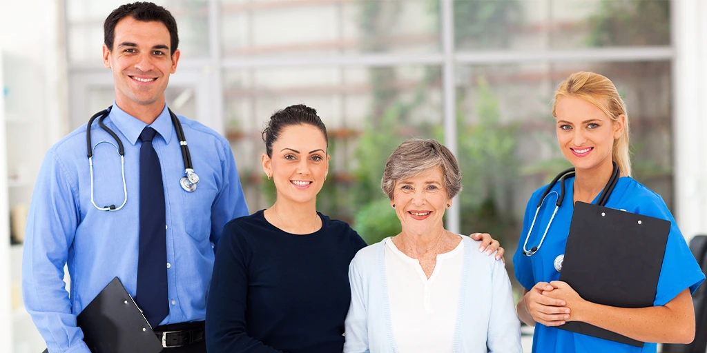 2 doctors and 2 people standing side by side